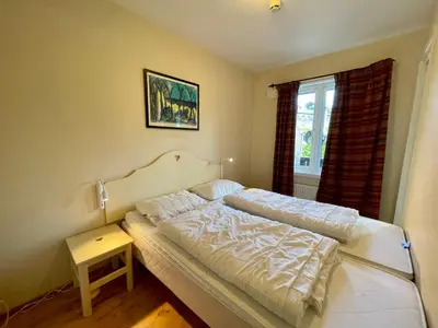 a bedroom with a bed and a window at Cozy 2-Bedroom Retreat In The Heart Of Nature in Beitostøl