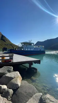 a boat is docked at a dock in the water at Cozy 2-Bedroom Retreat In The Heart Of Nature in Beitostøl