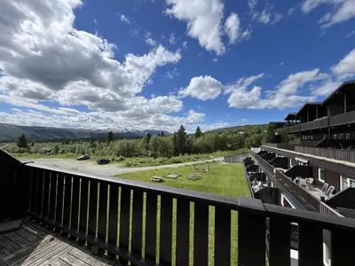 a view from the balcony of a condo with a view of a road at Small Family Retreat Two Bedrooms And Easy Access in Beitostøl