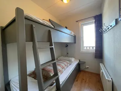 a bunk bed in a small room with a ladder at Small Family Retreat Two Bedrooms And Easy Access in Beitostøl