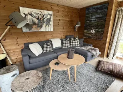 a living room with a couch and a table at ChaletMons, stor trivelig leilighet i Myrkdalen in Vossestrand