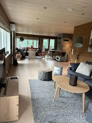 a living room with a blue couch and a table at ChaletMons, stor trivelig leilighet i Myrkdalen in Vossestrand