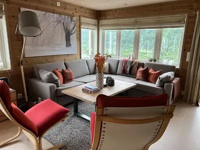a living room with a couch and a table at ChaletMons, stor trivelig leilighet i Myrkdalen in Vossestrand