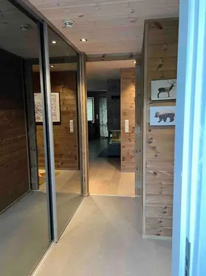 a room with glass doors and wooden walls at ChaletMons, stor trivelig leilighet i Myrkdalen in Vossestrand