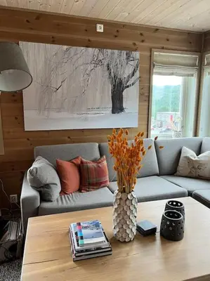 a living room with a couch and a table at ChaletMons, stor trivelig leilighet i Myrkdalen in Vossestrand