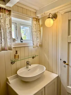 a bathroom with a sink and a window at Veslegarden in Lærdalsøyri