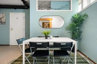 a dining room with a white table and chairs at BUDGETEL- Kong Oscarsgate 48 in Bergen