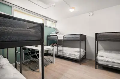a room with three bunk beds and a desk at BUDGETEL- Kong Oscarsgate 48 in Bergen