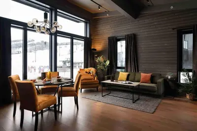 a living room with a couch and a table at Riddergaarden Hotel & Mountain Lodge, Beitostølen in Beitostøl
