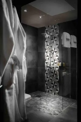 a bathroom with a shower with a toilet and a sink at Riddergaarden Hotel & Mountain Lodge, Beitostølen in Beitostøl