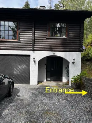a house with a garage with the word entrance at Koia Guesthouse in Flesberg