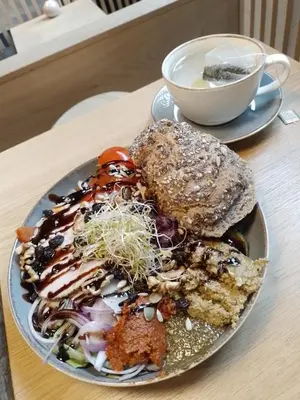 a plate of food on a table with a cup of coffee at Cosy apartment near city center in Bergen