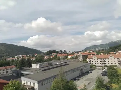 a view of a city with buildings and mountains at Cosy apartment near city center in Bergen