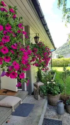 a house with pink flowers on the side of it at Feriehus i Lærdal in Mjeldo