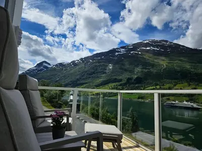 a balcony with a view of a mountain at Modern cabin with panorama view in Olden