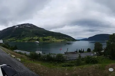 a view of a lake with a boat in the water at Modern cabin with panorama view in Olden