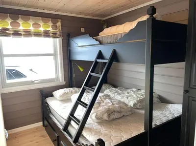 a bunk bed with a ladder in a room at Rekkehus i Myrkdalen in Helgatun