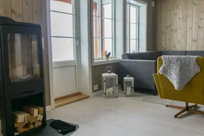 a living room with a couch and a tv at Leilighet Overøye Hyttegrend in Stordal