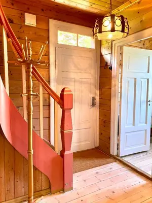 a staircase in a wooden house with a door at Stryn - Faleide - hus ved fjorden in Stryn