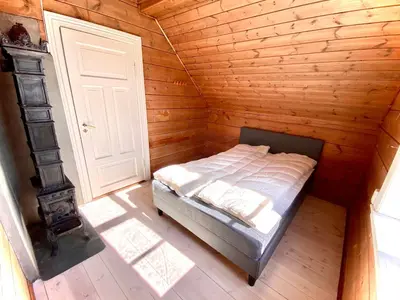 a bedroom with a bed in a wooden room at Stryn - Faleide - hus ved fjorden in Stryn