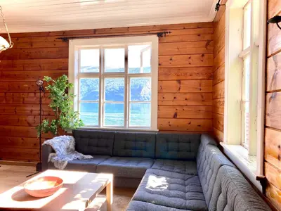 a living room with a couch and a table at Stryn - Faleide - hus ved fjorden in Stryn