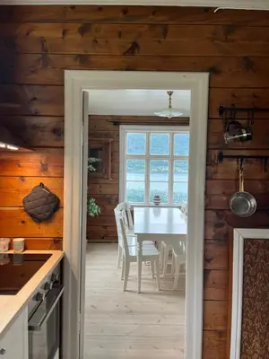 a kitchen and dining room with a table and chairs at Stryn - Faleide - hus ved fjorden in Stryn