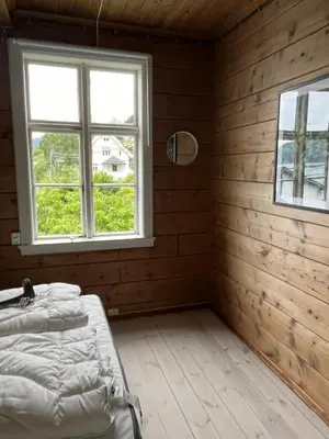 a bedroom with a bed and a window at Stryn - Faleide - hus ved fjorden in Stryn