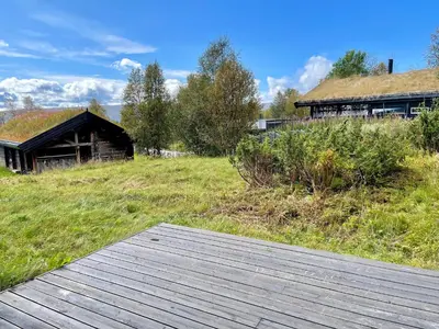 a wooden boardwalk in front of a building at Spacious Apartment In Central Beitostølen in Beitostøl