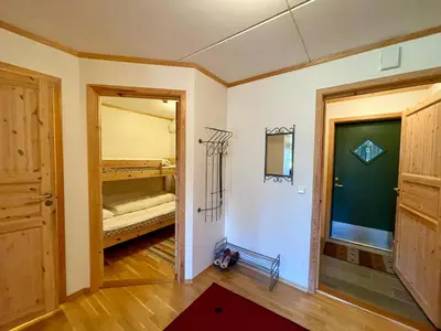 a room with a bedroom with a bed and a doorway at Spacious Apartment In Central Beitostølen in Beitostøl