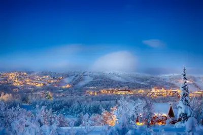 a view of a city in the snow at night at Spacious Apartment In Central Beitostølen in Beitostøl