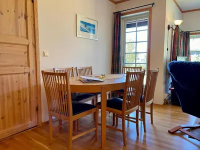 a dining room with a wooden table and chairs at Spacious Apartment In Central Beitostølen in Beitostøl