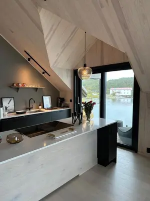 a kitchen with a counter with flowers on it at Amundøya Penthouse in Kristiansund