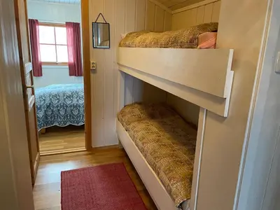 two bunk beds in a small room with a mirror at 2-Bedroom Apartment With Balcony & Fireplace! in Beitostøl