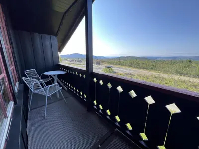 a balcony with a table and chairs and a view at 2-Bedroom Apartment With Balcony & Fireplace! in Beitostøl