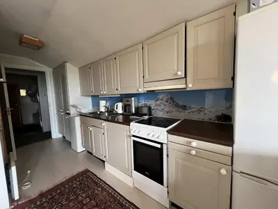 a kitchen with white cabinets and a stove top oven at 2-Bedroom Apartment With Balcony & Fireplace! in Beitostøl