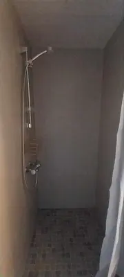 a shower in the corner of a bathroom at Hos Jurate in Fagernes