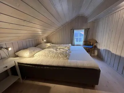 a large bed in a room with a ceiling at Panorama 4 C Ski Inn And Out With Views Of Slettefjell in Beitostøl