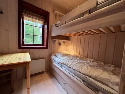 a room with two bunk beds and a desk at Panorama 4 C Ski Inn And Out With Views Of Slettefjell in Beitostøl