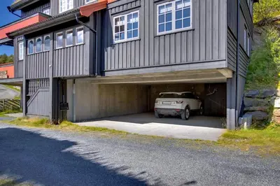 a car is parked inside of a garage at Panorama 4 C Ski Inn And Out With Views Of Slettefjell in Beitostøl
