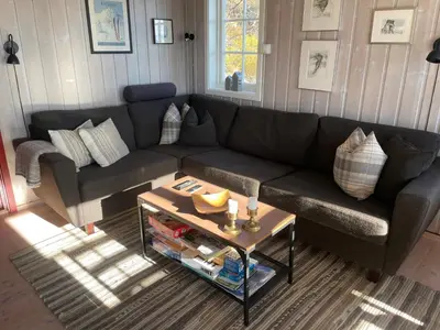a living room with a couch and a table at Panorama 4 C Ski Inn And Out With Views Of Slettefjell in Beitostøl