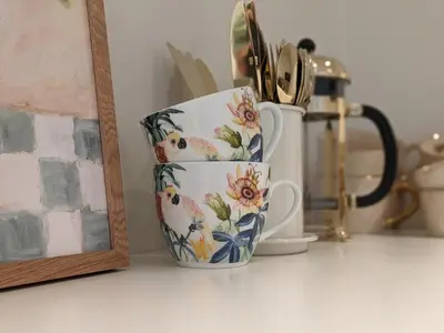 a group of cups sitting on a counter next to a mirror at Meget hjemmekoseligISentraltINyoppusset leilighet in Bergen