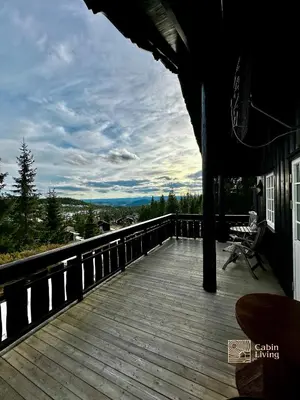 a porch with a wooden deck with a view at Cozy spacious cabin with sauna at Natrudstilen in Ringsaker