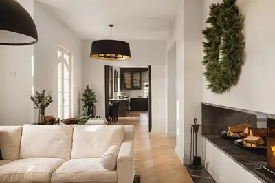 a living room with a white couch and a fireplace at Hopsneset Luxury Villa in Bergen