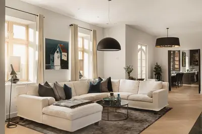 a living room with a white couch and a table at Hopsneset Luxury Villa in Bergen