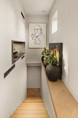 a hallway with a staircase with a plant in a vase at Hopsneset Luxury Villa in Bergen