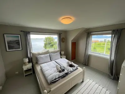 a bedroom with a bed with two teddy bears on it at Sjønært feriehus, båt tilgjengelig for leie in Ålesund