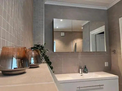 a bathroom with a sink and a mirror at Fjord house with a private bay, boats and sauna! in Etnesjøen