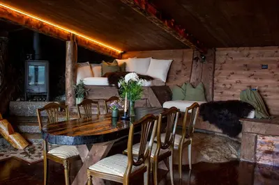 a room with a table and chairs and a bed at GapaLux in Levanger