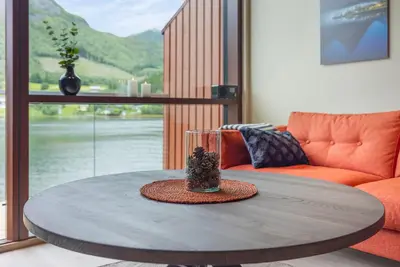 a coffee table in a living room with a couch at Rorbu in Sykkylven