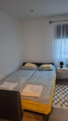 a large bed in a room with a window at Duzy apartament w centrum Ålesund in Ålesund